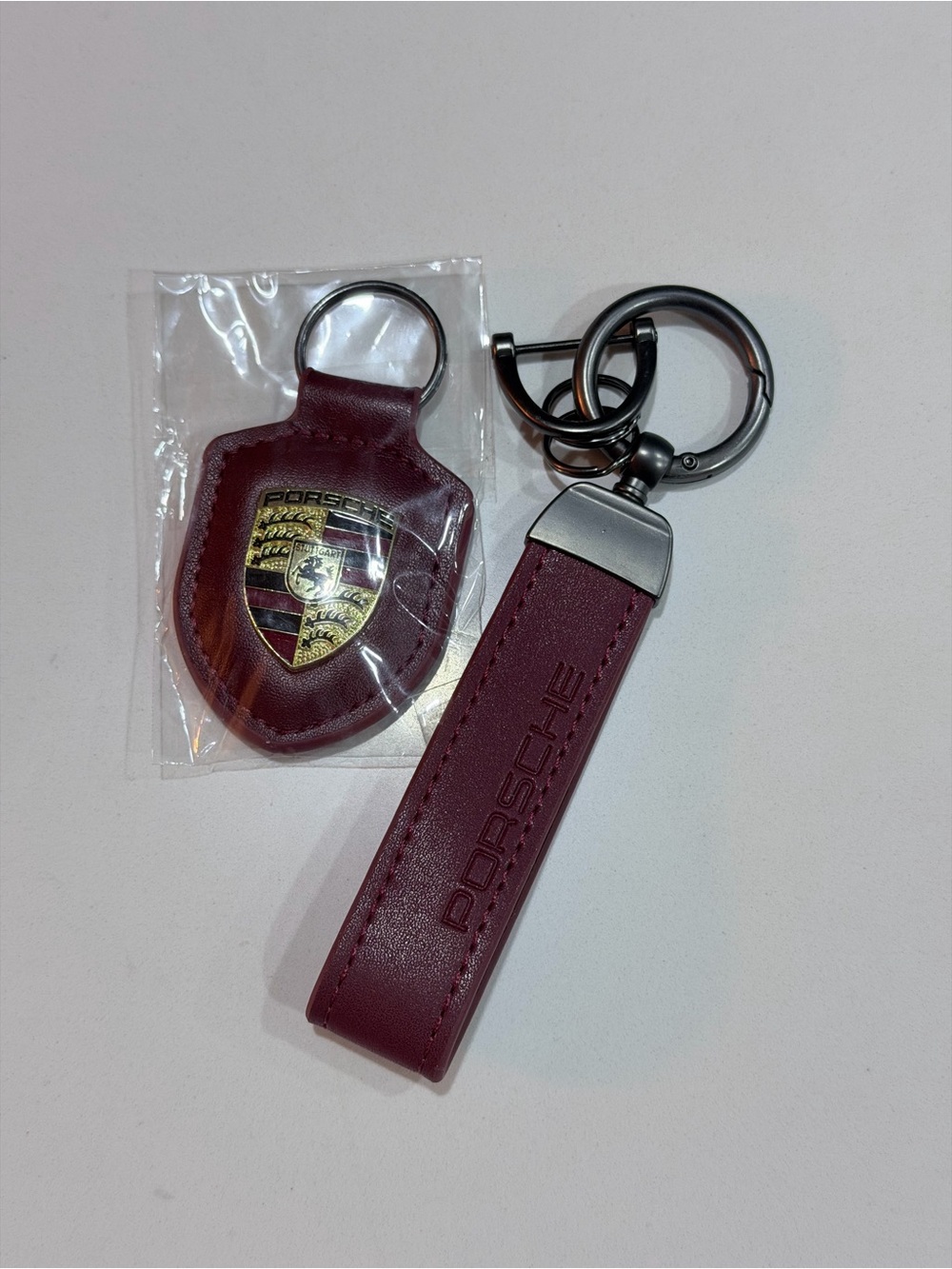 Bordeaux red leather strap with debossed lettering and shield crest